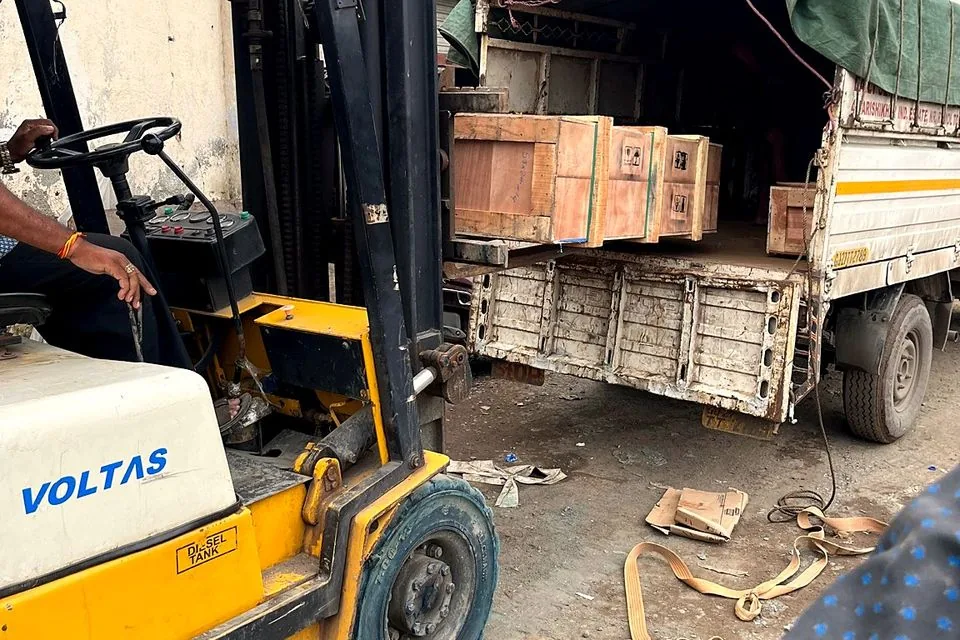 Forklift loading crated export goods onto a truck at the JSS facility in Mumbai