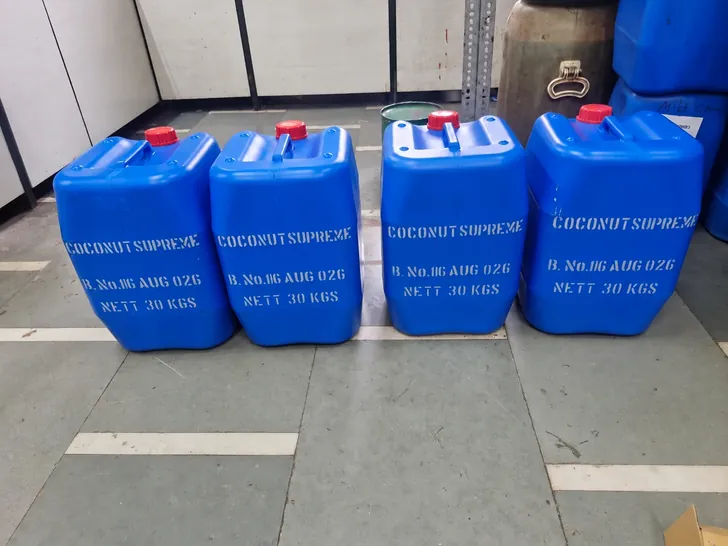 Four 30 kg coconut supreme flavour cans stencilled with batch number and nett weight