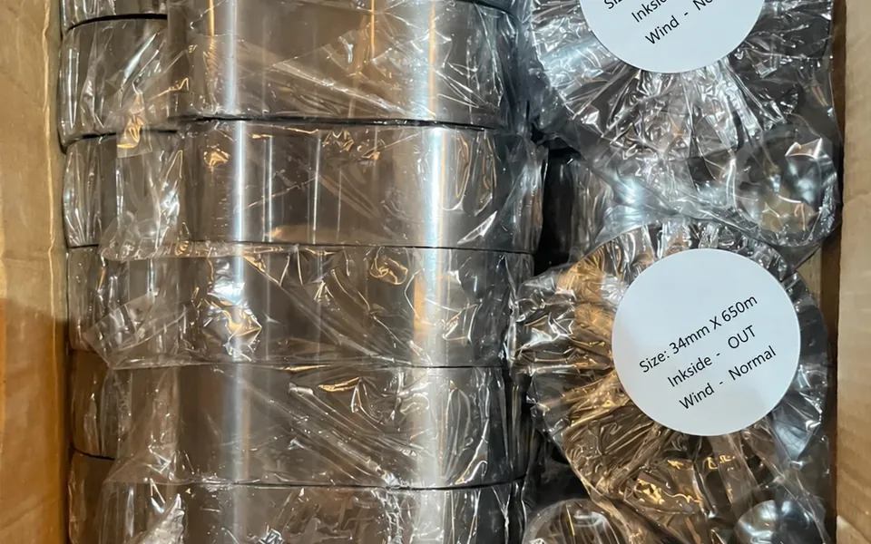 Carton of wrapped thermal transfer ribbons, labelled 34 mm by 650 m, ink side out