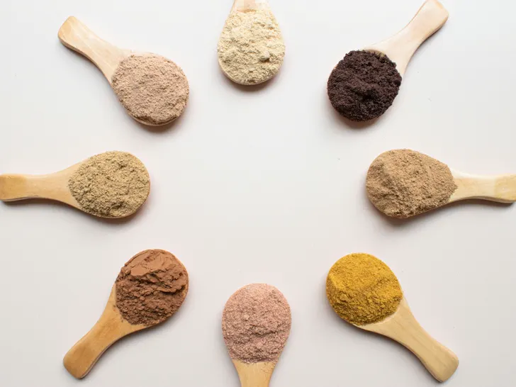 Six food powders on wooden spoons